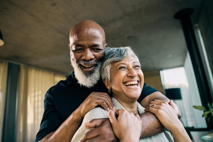 Active Retired African-American Couple Sharing a Laugh in Modern Home Kitchen
