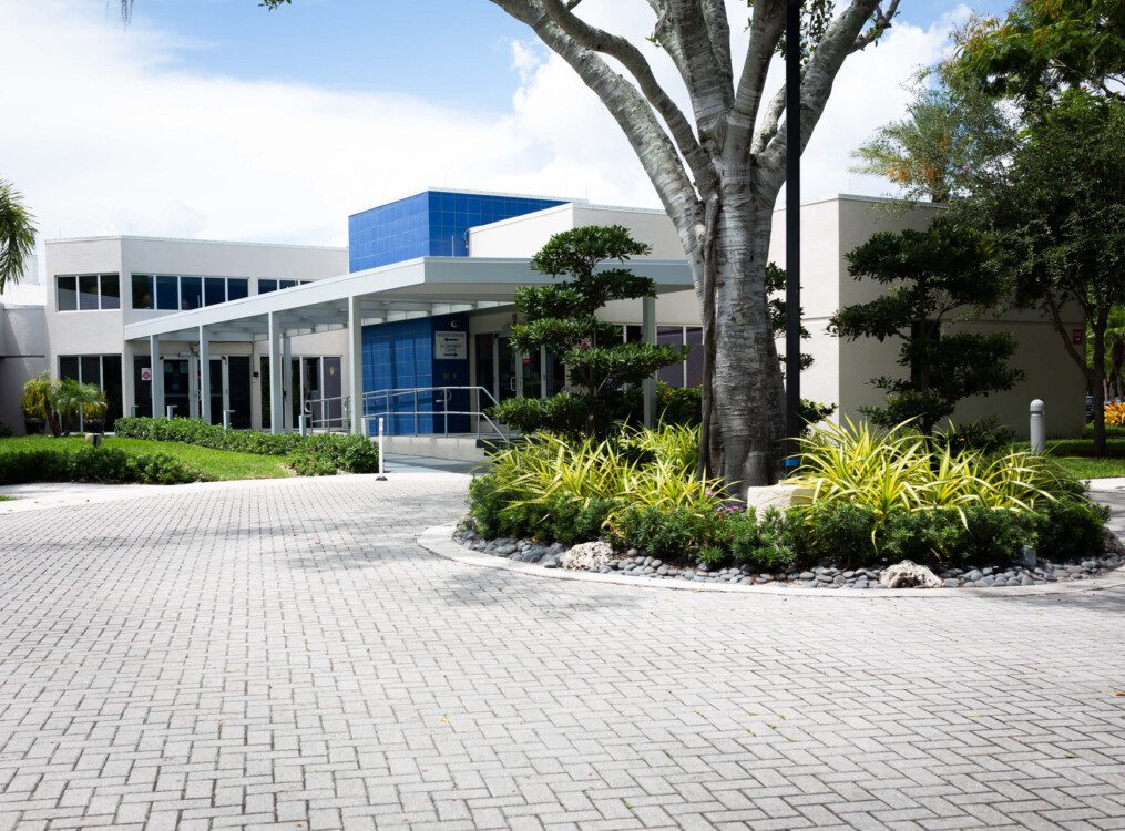 exterior view of driveway and landscaping in front of an outpatient clinic at Harbour's Edge Senior Living Community