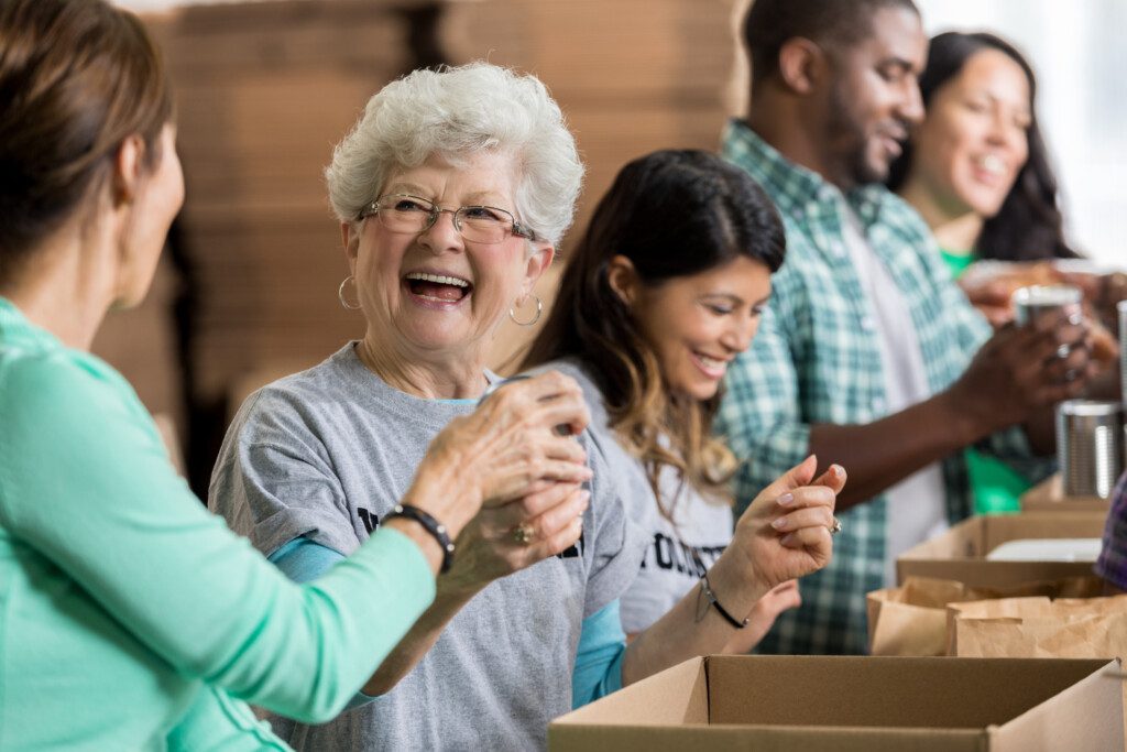 Vibrant older woman joyfully volunteers her time