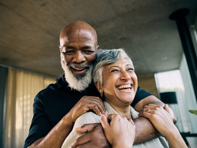 Active Retired African-American Couple Sharing a Laugh in Modern Home Kitchen